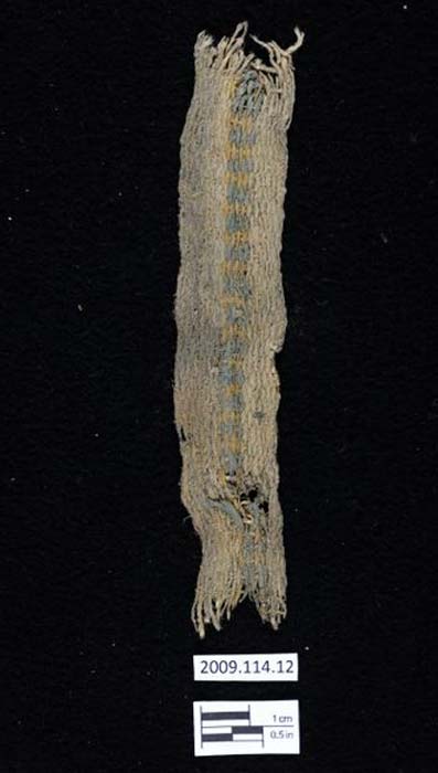 A cotton band or belt from Huaca Prieta which is 4100 -3500 years old. It has an indigo-blue center stripe and yellow ochre. 