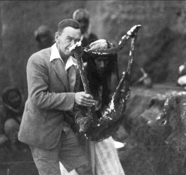 Leonard Woolley holding the hardened plaster mold of the Sumerian Queen's Lyre, 1922. 