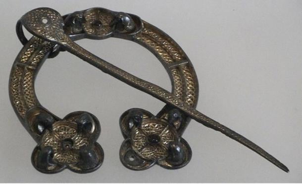 The Rogart brooch, a Pictish penannular brooch, Scotland, 8th century, silver with gilding and glass.