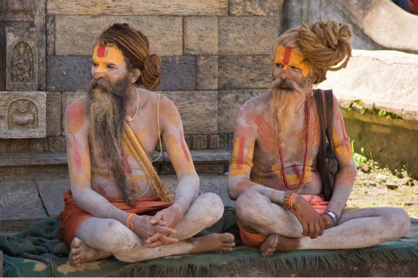 Two Hindu sadhus near Pashupatinath Temple in Kathmandu, Nepal. Usually sadhus live by themselves, on the fringes of society, and spend their days in their pursuit of moksha / mukthi