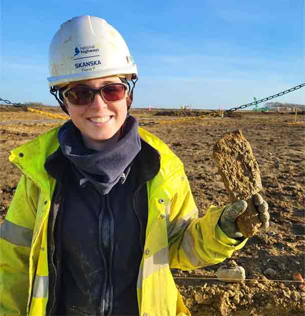 Archaeologist Fiona with an iron blade, possibly a ‘coulter’ from a plough. (MOLA)