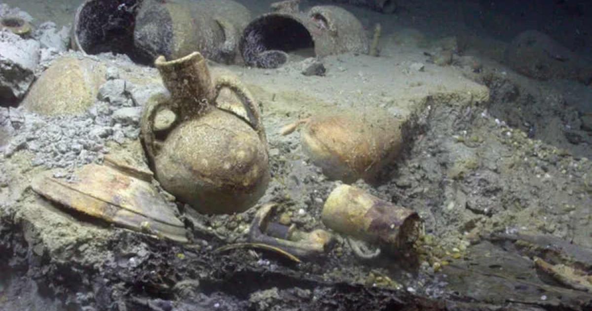 In situ artifacts from Algiers shipwreck, on top of wooden hull elements in the stern of the Barbary Corsair wreck.