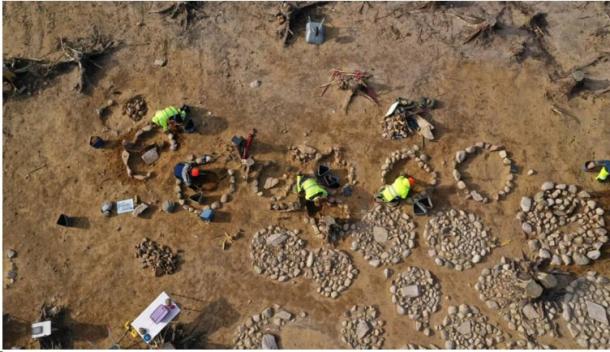 Archaeologists at work in a large burial field in southeastern Norway, where 40 circular stone formations with cremated bone remains, mostly from children, were found placed in the middle. (Museum of Cultural History/Science Norway)