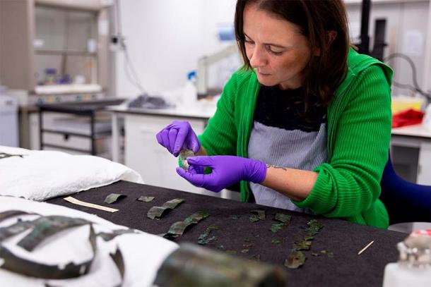 Conservator Bethan Bryan working on the Roman arm guard. (Duncan McGlynn / National Museums Scotland)