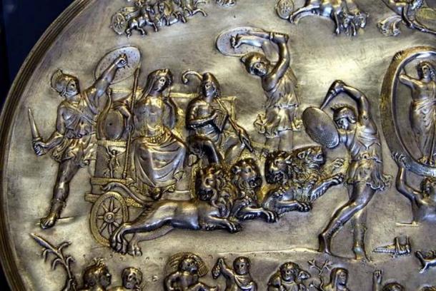 Cybele and Attis (seated right, with Phrygian cap and shepherd's crook) in a chariot drawn by four lions, surrounded by dancing Corybantes (detail from the Parabiago plate; embossed silver, c. 200–400 AD, found in Milan, now at the Archaeological Museum of Milan).