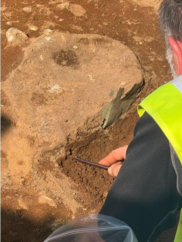 Excavation of newly found piece of the bucket. (©National Trust)