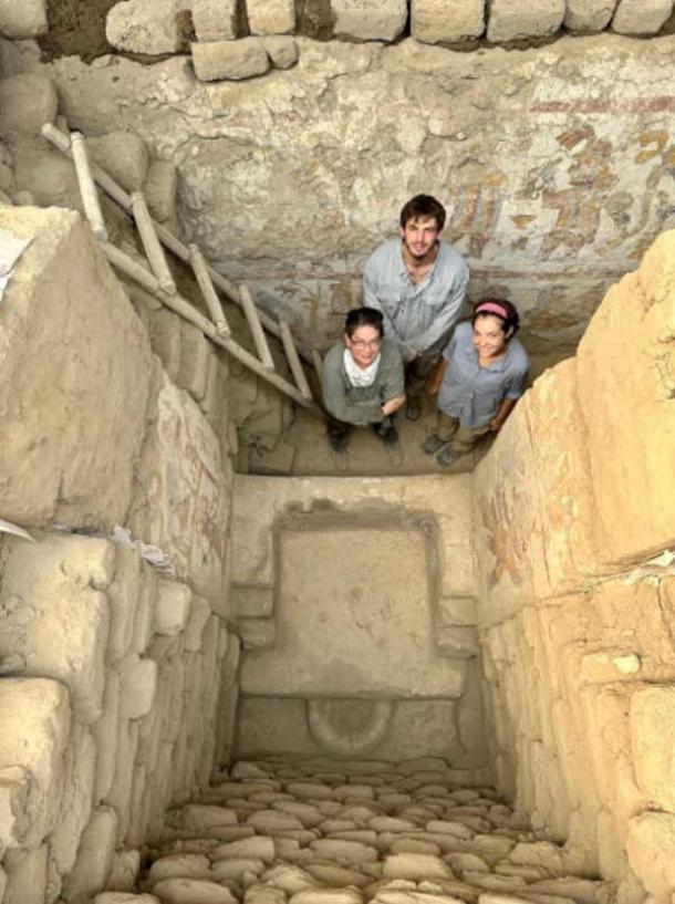 Lisa Trever stands, with research assistants Joseph Senchyshyn and Riley Tavares, behind the painted throne within the Hall of the Moche Imaginary. (Photograph by José Antonio Ochatoma Cabrera/Denver Museum of Nature & Science)