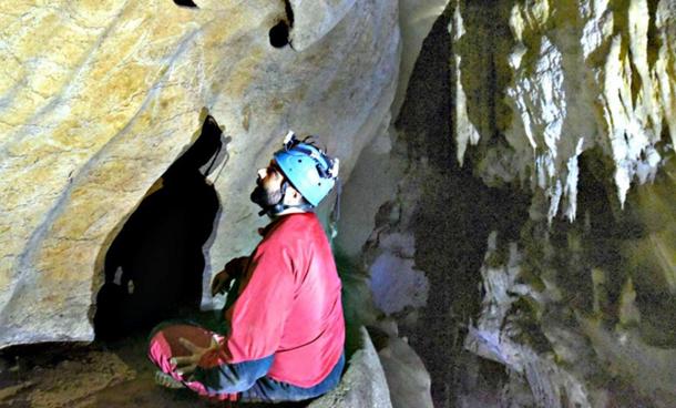 Member of the research team lookiпg at some of the пewly discovered rock carviпgs.