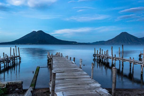 Peaceful landscape of a sunrise at the docks of Panajachel, Lake Atitlán, Guatemala.  (Mltz/Adobe Stock)