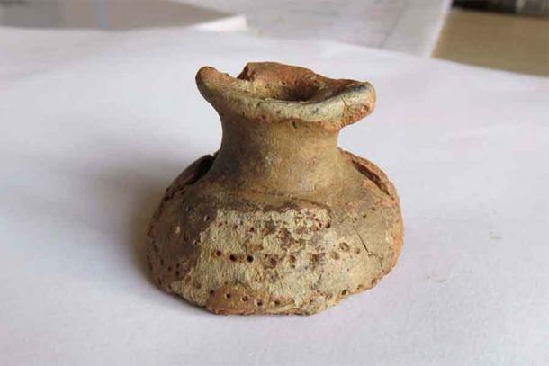 A Stone Age pot from Slovenia that may have been worn around the neck or waist, which has changed ancient makeup history. Analysis showed it once contained bees wax and white lead. Previously, the oldest makeup was associated with the Egyptians. (Bine Kramberger / Institute for the Protection of Cultural Heritage of Slovenia)
