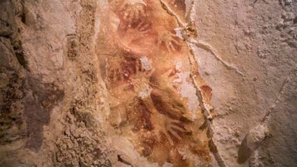 Prehistoric hand stencils from a cave in Indonesia. (Kinez Riza/Nature)