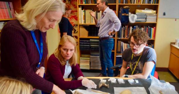 Researchers looking at Kendrick’s Cave human remains. (Dr Rhiannon Stevens, Dr Tom Booth) (J Tripp / Nature)