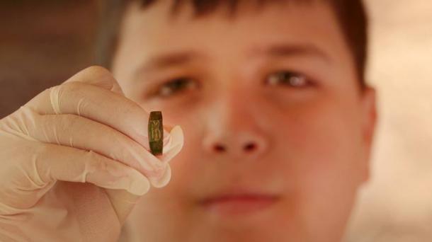 Yair Whitson and the ring he found. (Emil Eljam/Antiquities Authority)