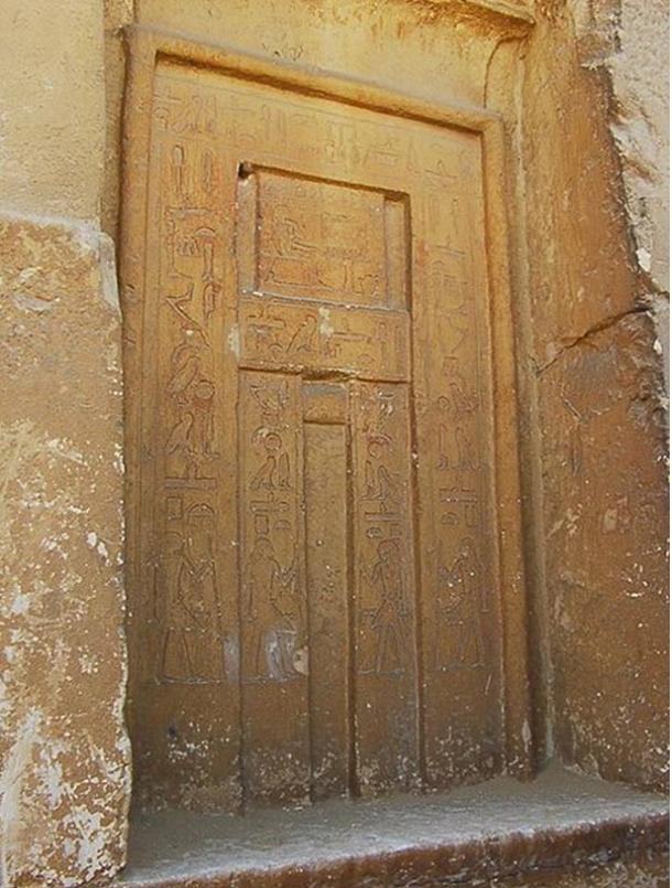 False door with depiction of tomb owner sitting in front of an offering table (rectangular section in top half of door).