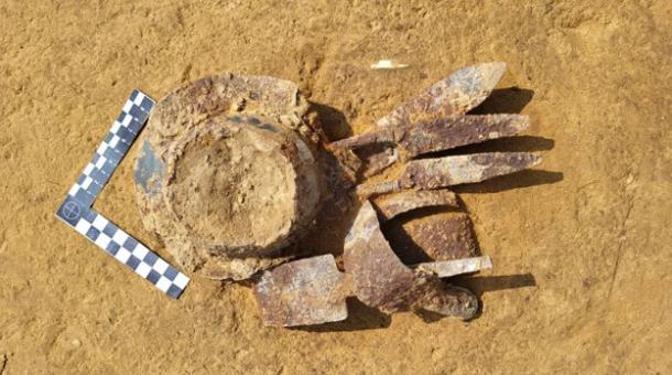 Equipment including bent sword, shears, and umbo from the center of a shield found at the Vandal cemetery.