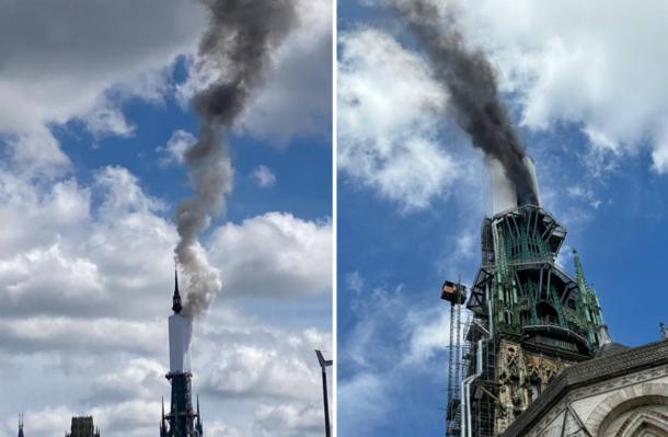 Tower of Rouen Cathedral billows smoke.