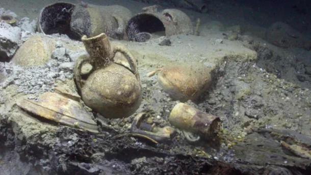 In situ artifacts from Algiers shipwreck, on top of wooden hull elements in the stern of the Barbary Corsair wreck.