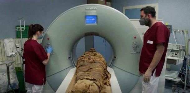 Here the Egyptian priest mummy is about to “enter” the CT scan machine in Milano, Italy. (video clip image / Reuters)