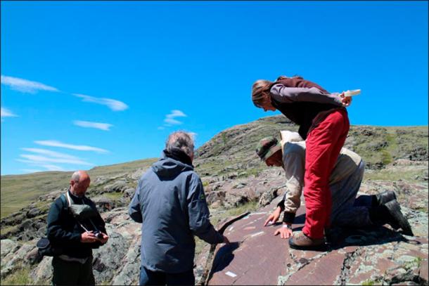 The team of archaeologists inspecting the Paleolithic rock art at Kalgutinsky Rudnik, Russia. (Hugues Plisson & Lidia Zotkina / Siberian Times)