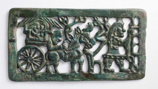 A traveling nomad family led by a man in belted jacket and trousers, pulling a nomadic cart. Belt buckle from Mongolia or southern Siberia, dated to 2nd-1st century BC (Xiongnu period). (Public Domain)