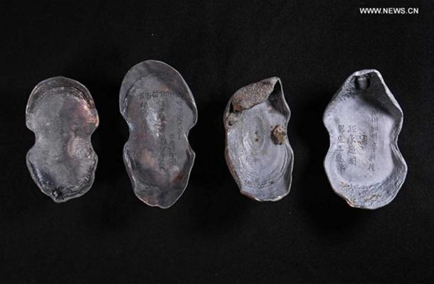 The treasure found in in Sichuan, China also includes these silver ingots with writing still visible on them.