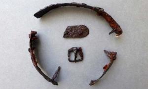 A buckle and part of a strap were found with the metal pieces. Credit: Border Archaeology